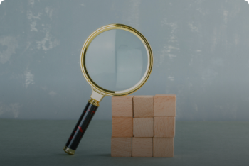conceptual-search-with-wooden-blocks-magnifying-glass-side-view 1.png
